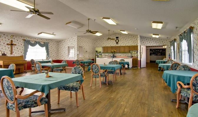 Brightly lit dining room with tables and chairs