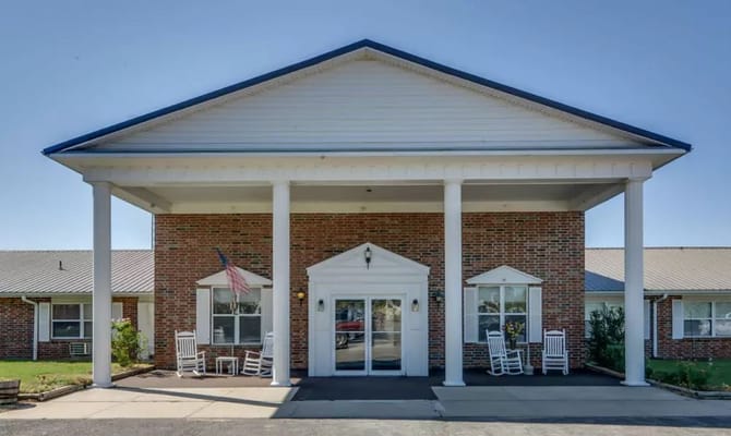 Building exterior of Pleasant Valley with rocking chairs