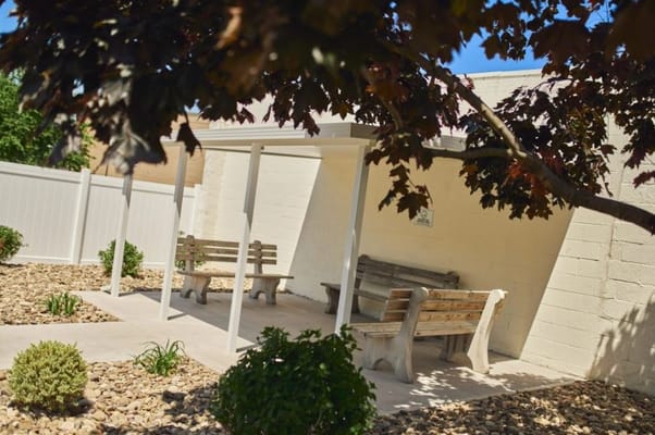 Shaded outdoor seating area with benches
