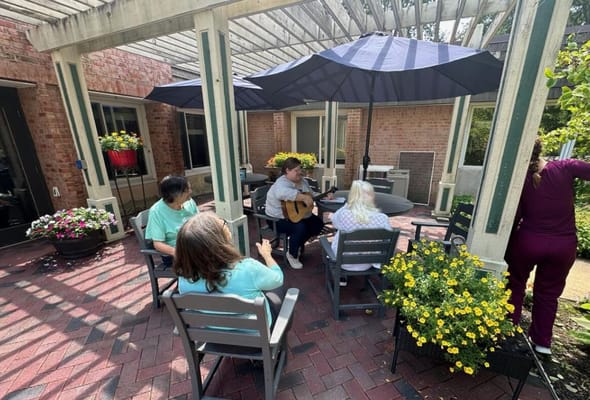 Residents enjoying an outdoor music session in a courtyard.