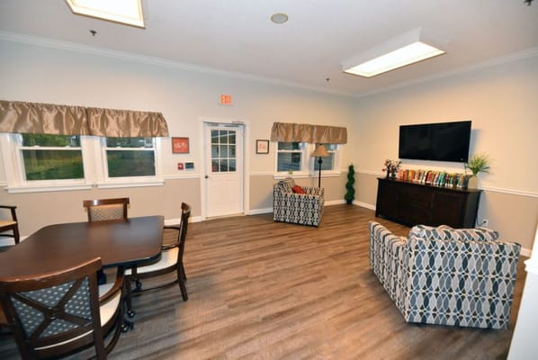 Cozy living room with armchairs, a small table, and a television