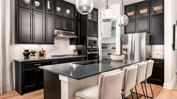 Stylish kitchen with black cabinets and a large island