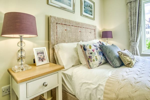 Stylish bedroom featuring a comfy bed and elegant decor.