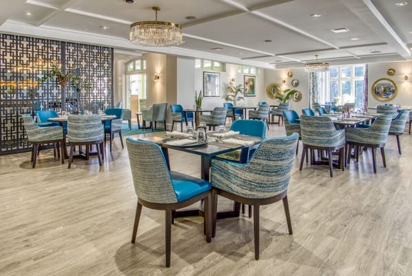 Bright dining area with blue chairs and stylish decor