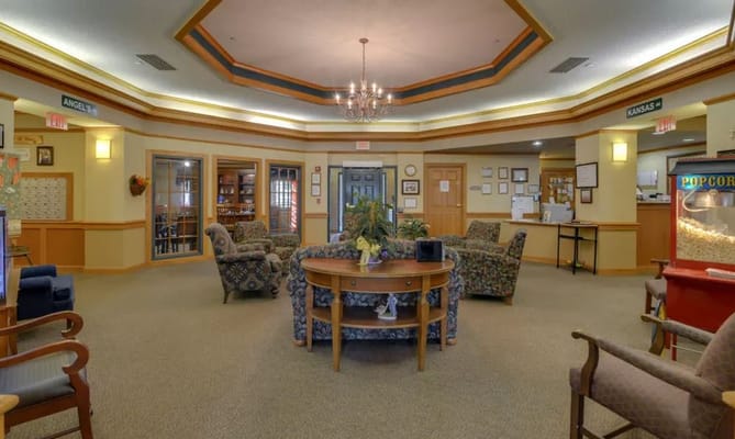 Lobby area with seating and a popcorn machine at River Bend.