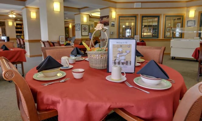 Table set for dining with red tablecloth and dishes