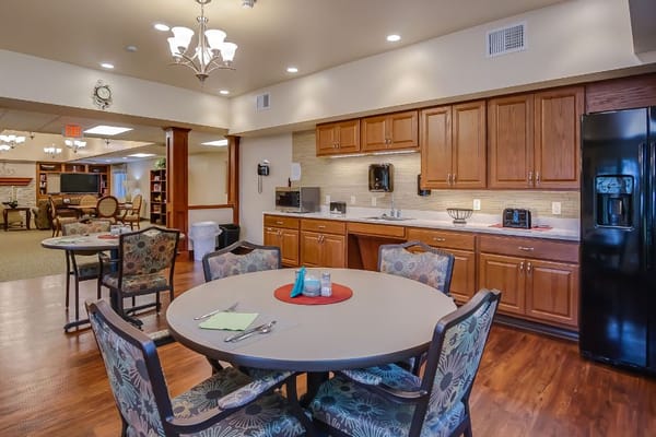 Cozy dining area with a round table and kitchenette