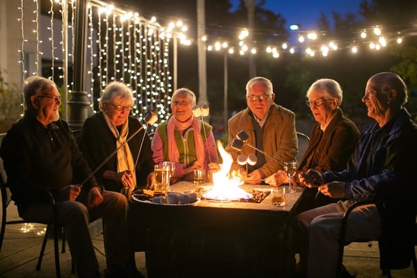Residents enjoying an evening by the fire pit, roasting marshmallows.