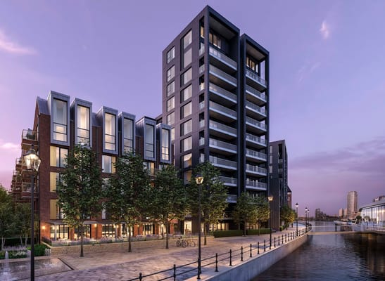 Modern residential buildings along a waterway at dusk