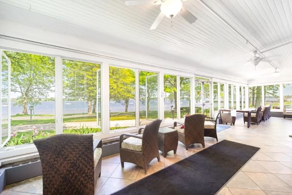 Bright sunroom with seating and lake view