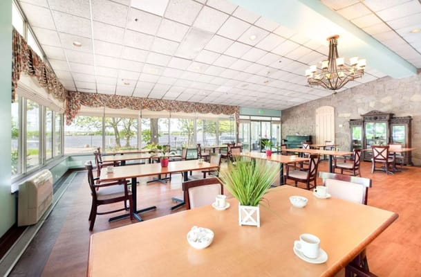 Spacious dining area with large windows and tables