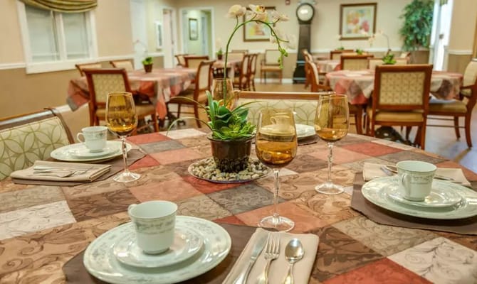 Table set for dining with elegant tableware and plants