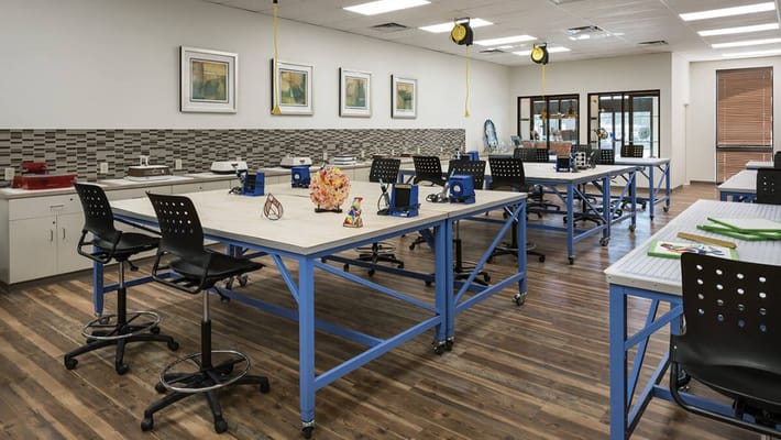 Art and craft activity room with tables and chairs