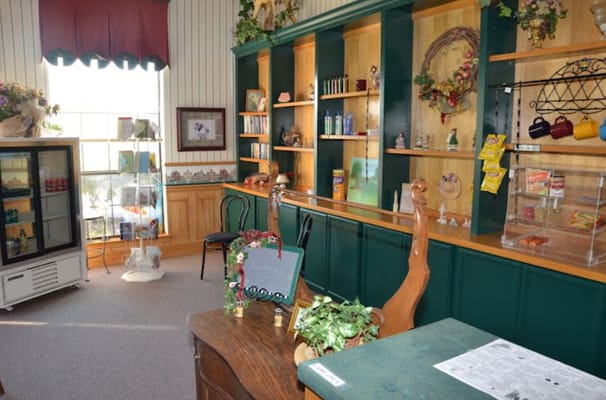 Cozy living area with shelves, seating, and a beverage fridge