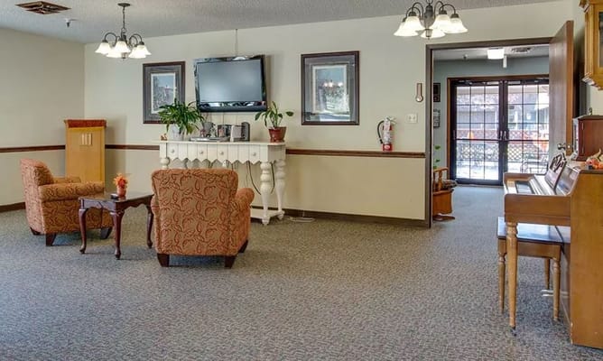 Cozy lobby with seating and a TV at Sabetha Manor