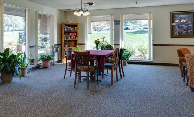 Cozy community room with a dining table and plants