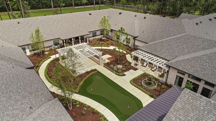 Aerial view of the landscaped courtyard featuring a putting green, fountain, and seating area.