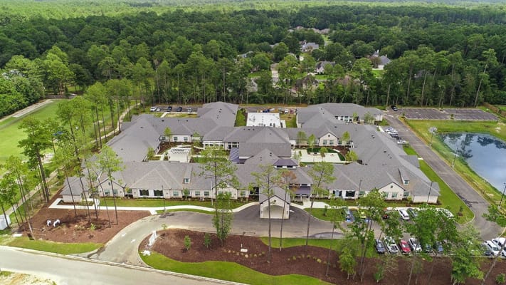 Aerial view of Sage Lake Senior Living facility surrounded by greenery.