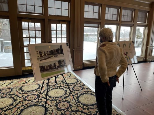 Senior resident looking at architectural plans inside the facility
