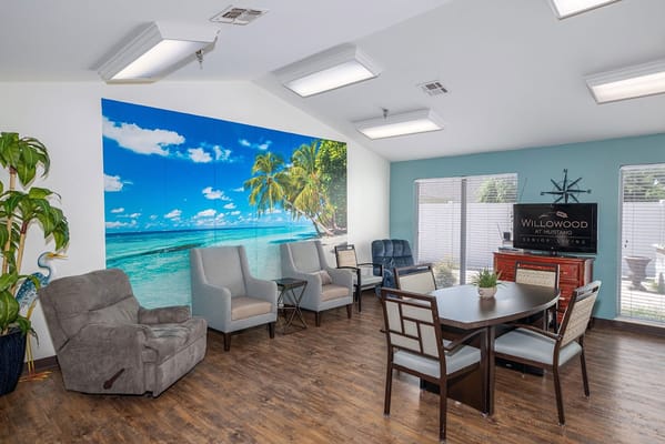 Lounge area featuring comfortable seating and a scenic wall mural