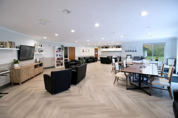 A spacious common area with seating and dining arrangements.