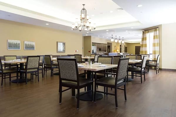 Bright dining room with tables set for meals