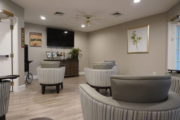 Cozy lounge area with circular chairs and a TV.
