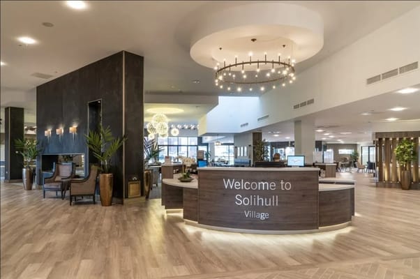 Modern lobby with a reception desk and elegant lighting