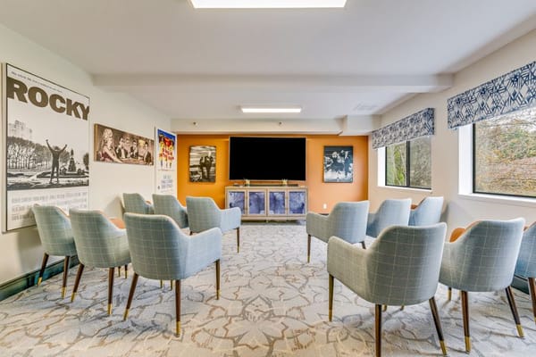 Spacious common room with comfortable seating and large TV.