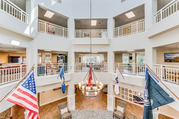Interior view of a bright common area with flags