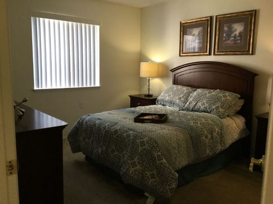 Cozy bedroom with a bed, nightstands, and window