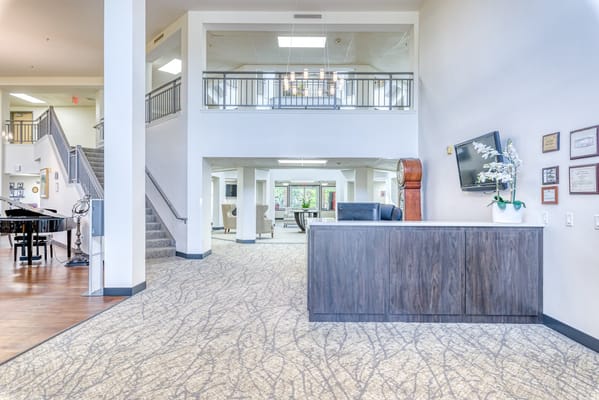 Lobby of Solstice Senior Living featuring a reception desk and seating area.