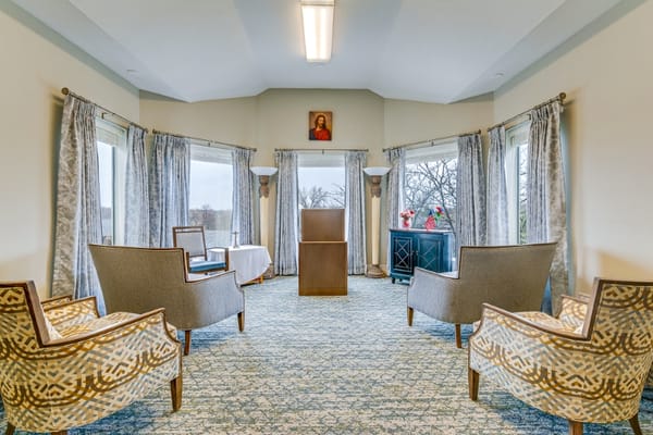 Bright common area with seating and large windows