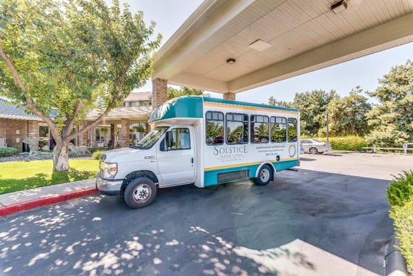 Solstice Senior Living shuttle bus parked near the entrance