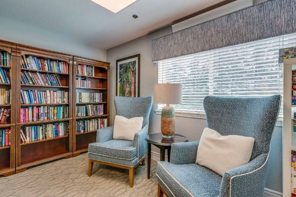 Cozy reading nook with bookshelves and chairs
