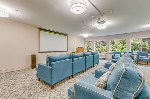 Common area with blue sofas and projector screen