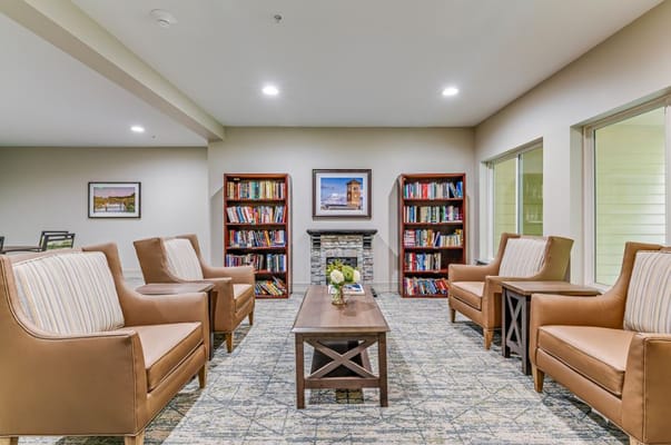 Common area with comfortable seating and bookshelves