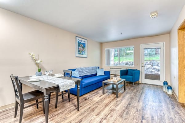 Cozy living room with blue furniture and dining area