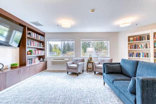Lounge area with comfortable seating and bookshelves