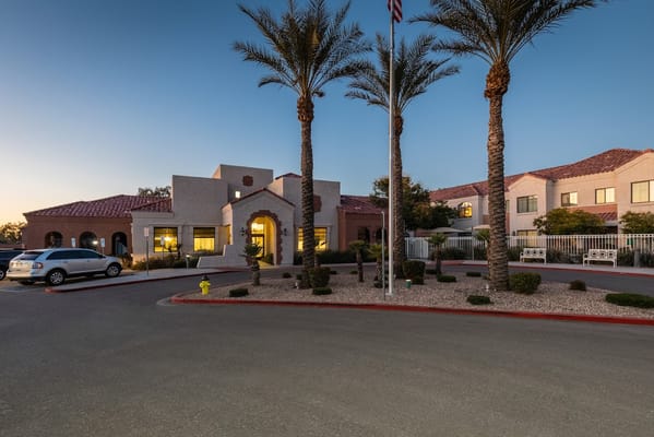 Welcoming entrance of Solterra Senior Living with palm trees