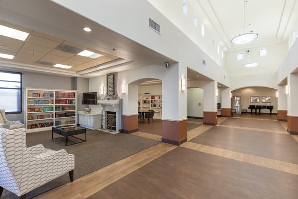 Bright and welcoming common area with seating and bookshelves