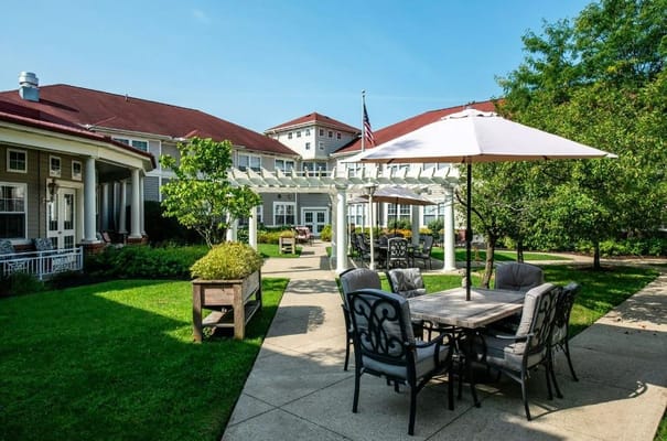 Shaded seating area with tables and chairs in the garden
