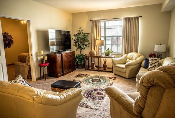 Bright living room with comfortable seating and a television.