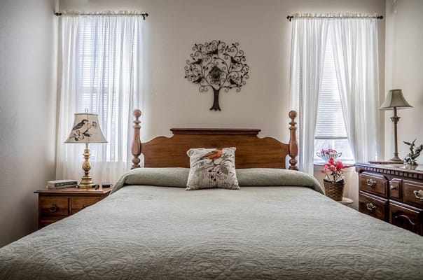 Well-decorated bedroom with a bed, lamp, and window
