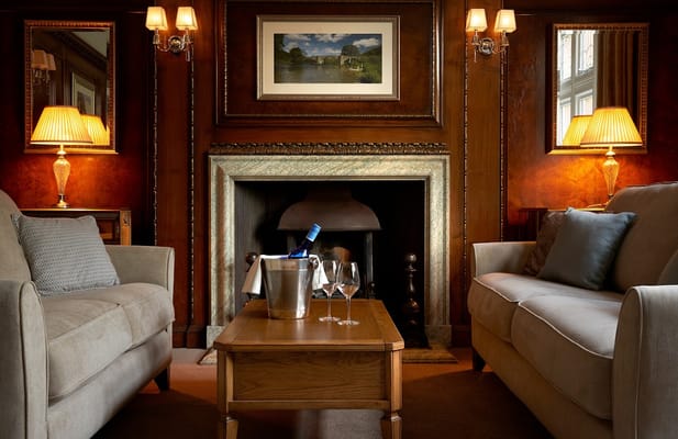 Lounge with two sofas, a coffee table, and a fireplace