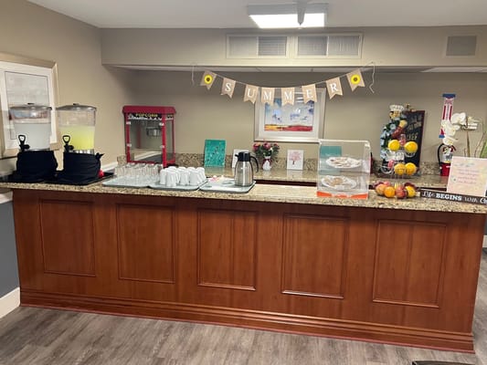 Refreshment station with drinks, snacks, and summer decorations