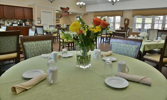 A beautifully set dining table with flowers in Spencer Place's dining room.