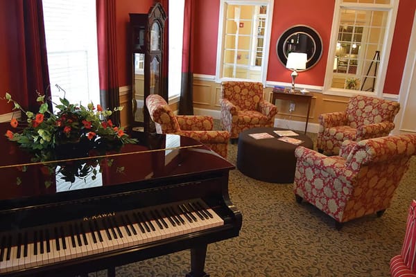 Interior lounge area with plush seating and a piano