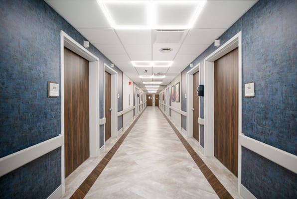 Interior hallway with patient rooms at Spring Creek Healthcare Center.