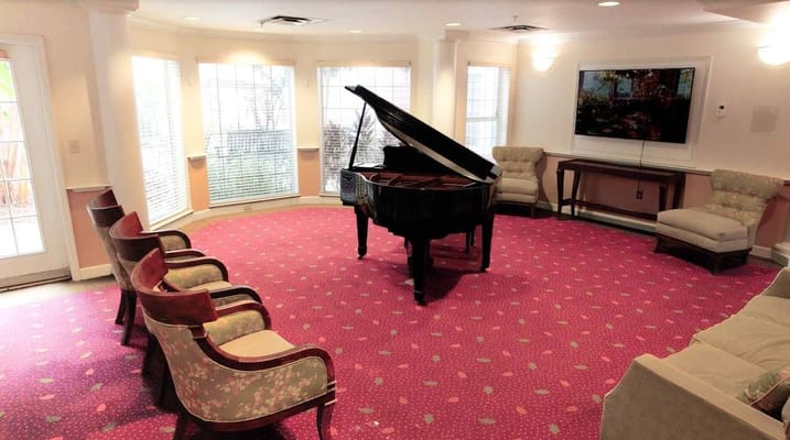 Piano in a common area with seating furniture